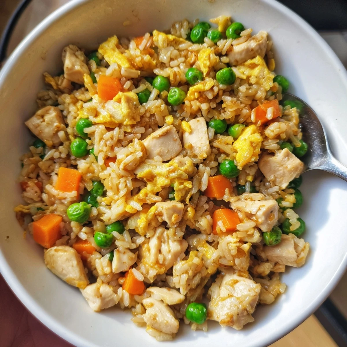 Delicious Easy Chicken Fried Rice served hot, featuring tender chicken and peas.