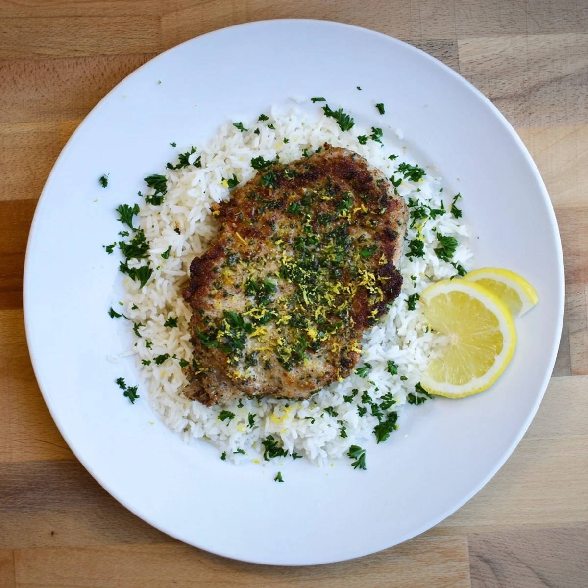 Golden-crusted Parmesan Herb Pork Chops, served with fluffy seasoned rice, a comforting dinner.