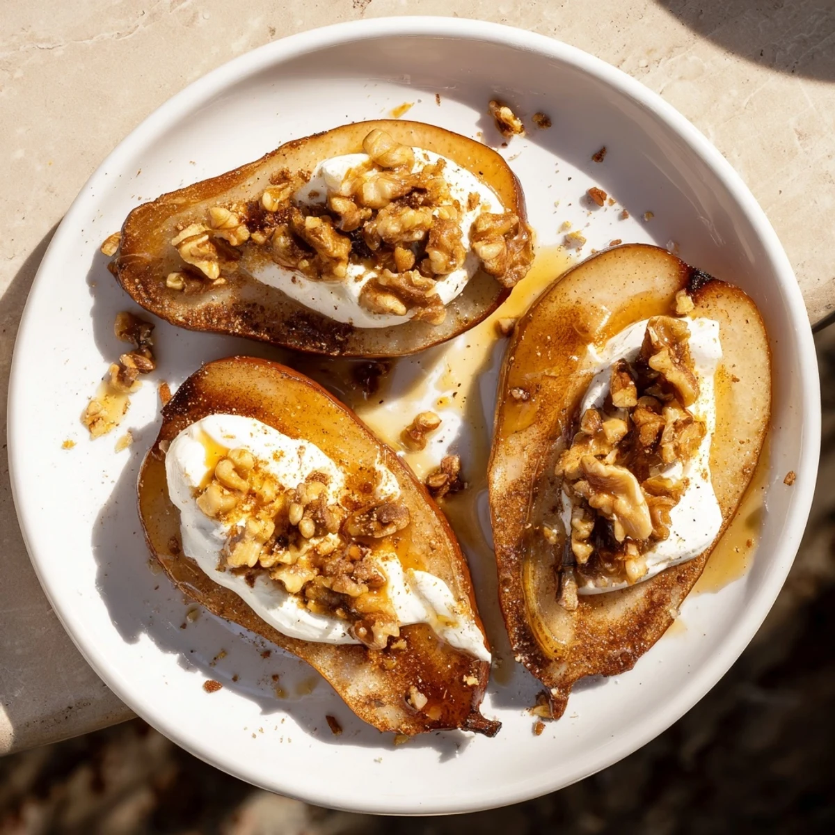 Golden-brown roasted pears, glistening with honey, paired with Greek yogurt for a simple dessert.