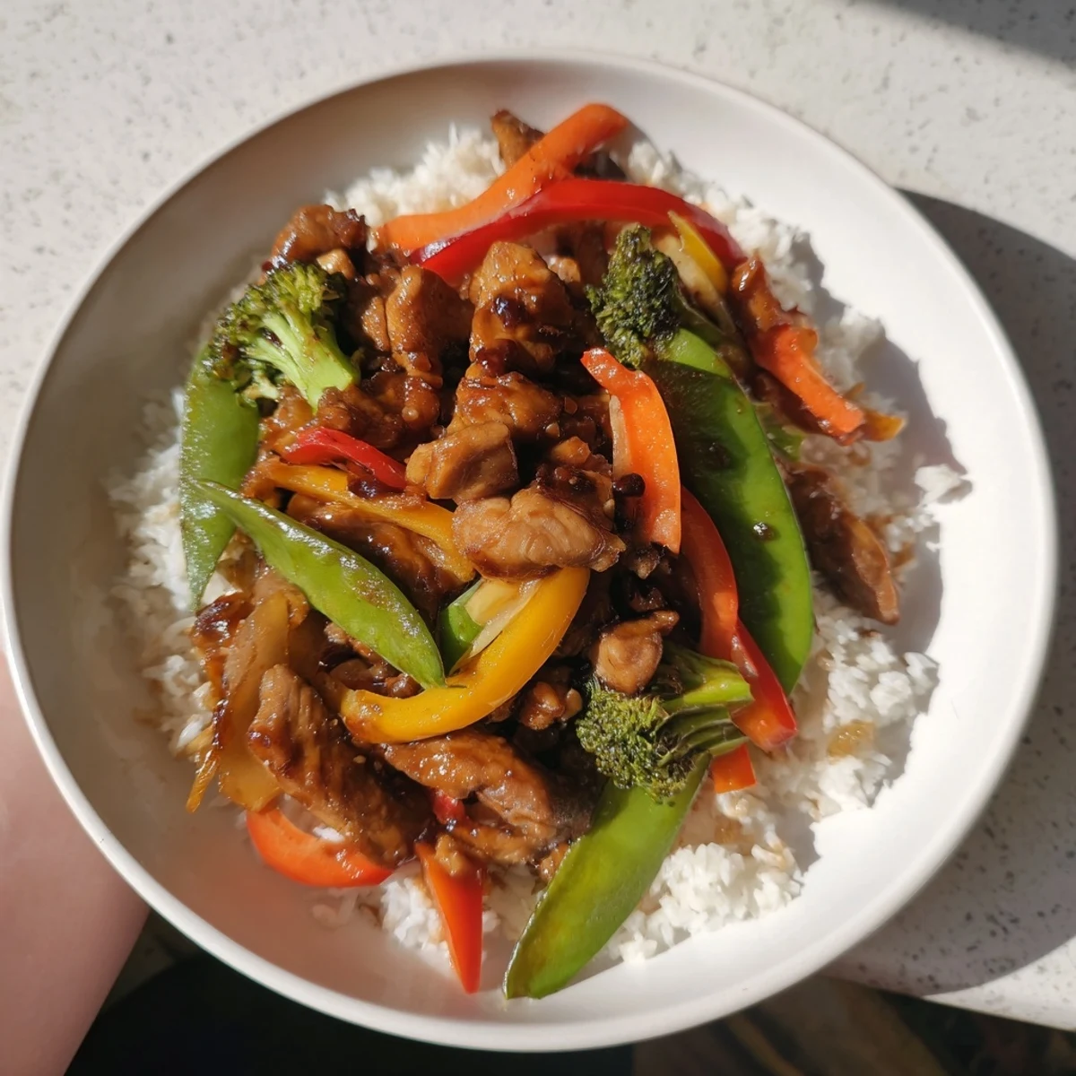 A bowl of delicious Chicken Stir-Fry with Vegetables and Rice, ready to serve with fluffy jasmine rice.