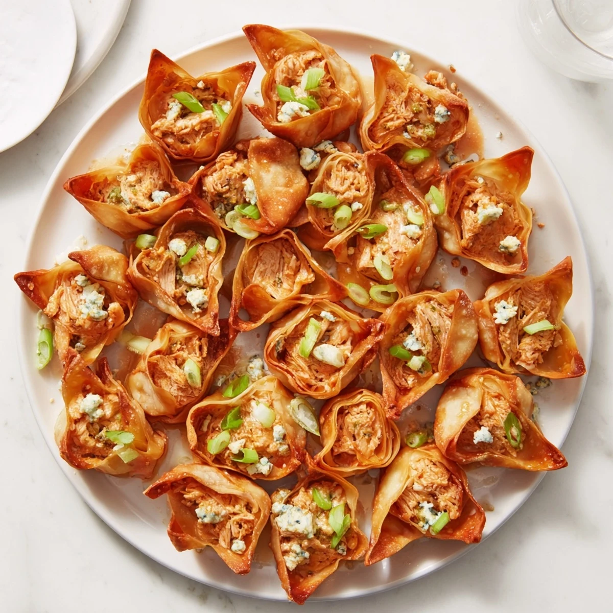 Enjoy warm Buffalo Chicken Dip Pinwheel Wontons, small golden rolls with a spicy buffalo chicken filling, perfect for game day.