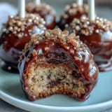 Festive Pot of Gold Cake Pops: chocolate cake pops dipped in black candy coating and topped with edible gold sprinkles for St. Patrick's Day.