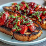 Juicy strawberries, sweet balsamic glazes crisp grilled sourdough for a delightful bite.