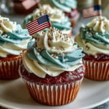 Festive Star-Spangled Banner Cupcakes with swirled red, white, and blue frosting.