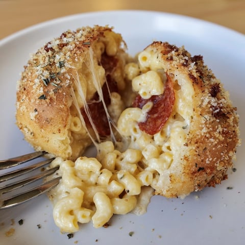 Golden Cheesy Pepperoni Mac Bombs, fresh from the oven, oozing cheese and comforting warmth.