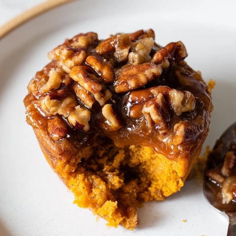 Moist pumpkin muffin pecan pie cups topped with crunchy pecans and maple syrup.  