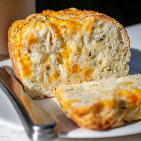 Delicious maple ginger cheesy jalapeño biscuit muffin loaf, golden and fluffy, ideal for brunch.  