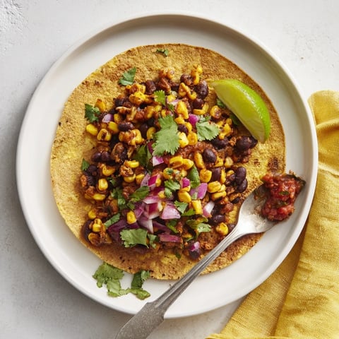 Colorful Quick Corn & Black Bean Tacos served with lime for a fresh twist.  