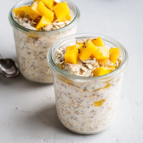 Creamy mango chia overnight oats topped with fresh tropical mango chunks.  