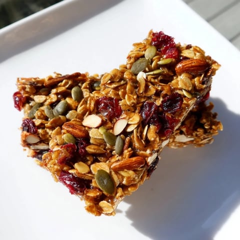 Golden-brown Roasted Pumpkin Seed & Cranberry Granola Bars, offering a delightful mix of textures and flavors.