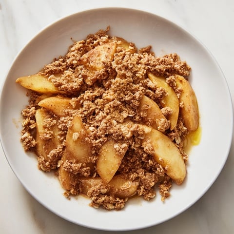 Golden-brown Apple Crisp with a bubbling fruit filling, ready to serve warm.