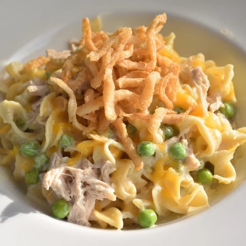 Creamy Tuna Noodle Casserole with crispy onions, a bubbling golden baked comfort food dish.