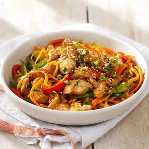 Steaming Lemon-Garlic Chicken Stir Fry with Noodles, a flavorful dish with colorful veggies and juicy chicken.