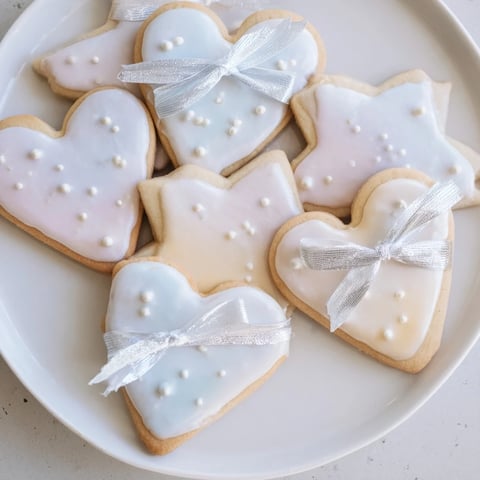 Golden-edged Mignonneries Coeurs et Étoiles Rubans cookies tied with satin ribbons, a delightful French dessert.