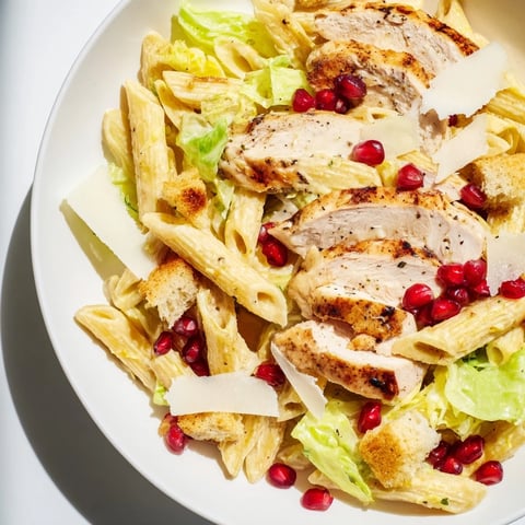 Chicken Caesar Pasta with pomegranate, a vibrant dish with juicy chicken and bursts of sweet pomegranate.