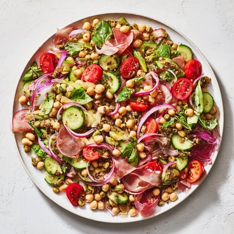 Dense Bean Salad with Prosciutto, bursting with vibrant colors and salty prosciutto ribbons.