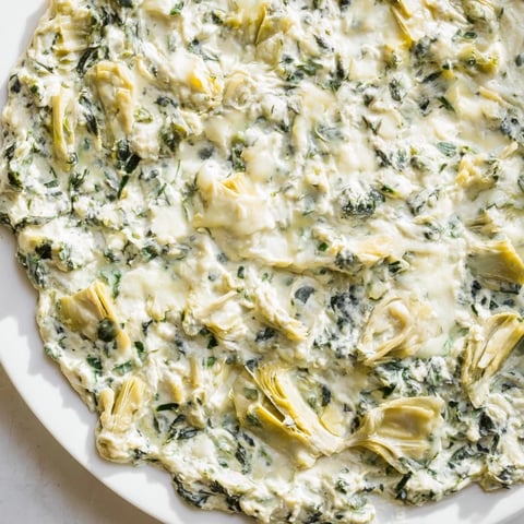Warm, bubbly spinach artichoke dip, served with crispy tortilla chips, ready to enjoy.