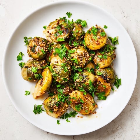 Golden, caramelized Honey Mustard Glazed Brussels Sprouts sit ready to serve, a flavorful side dish.