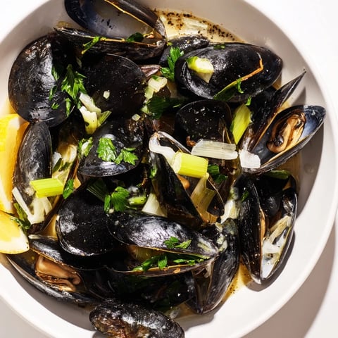 Steaming Belgian Moules Marinière in a pot, the mussels are plump, flavorful, and ready to serve.