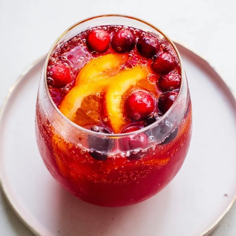 Festive 3-Ingredient Holiday Punch, ruby-red and bubbly, ready for your holiday party guests.