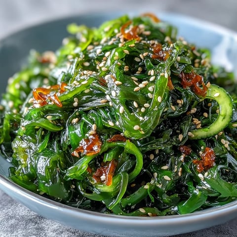 Seaweed Salad with Ponzu: A vibrant mix of tender seaweed and crisp vegetables tossed in tangy ponzu dressing with sesame seeds.  