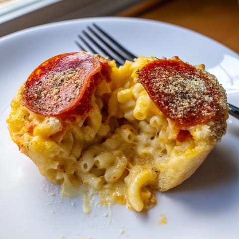 Close-up of homemade Cheesy Pepperoni Mac Bombs: golden crust, bubbling cheese, savory aroma.