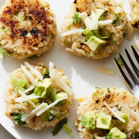 Crispy fried Avocado Cheddar Rice Cakes cooling, vibrant with green onion and herbs.