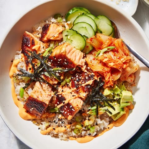 Golden crispy rice beneath succulent salmon, creating a mouthwatering rice bowl.  