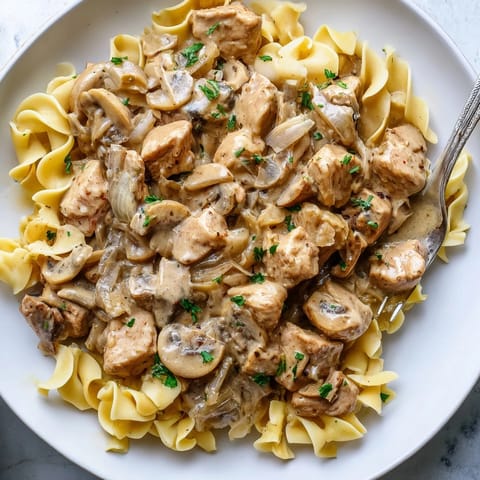 Delicious Creamy Chicken Stroganoff featuring succulent chicken in rich mushroom sauce.  
