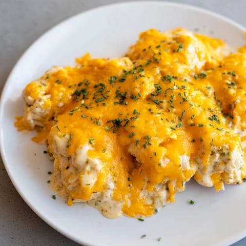 Golden-brown Cheddar Ranch Chicken Bake, creamy and savory, served with fresh chives.  