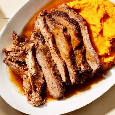 Fork-tender Classic Brisket served with golden mashed sweet potatoes, ready for a hearty family meal.