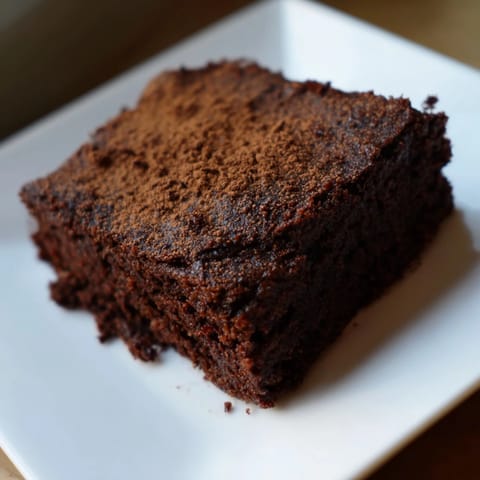 Warm, gooey Pumpkin Workout Brownies fresh out of the oven, ready to enjoy with a coffee.