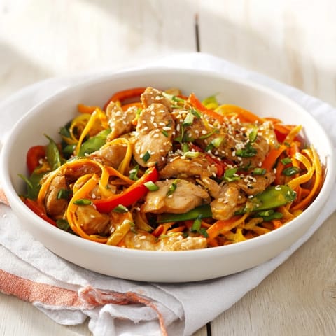 Steaming Lemon-Garlic Chicken Stir Fry with Noodles, a flavorful dish with colorful veggies and juicy chicken.