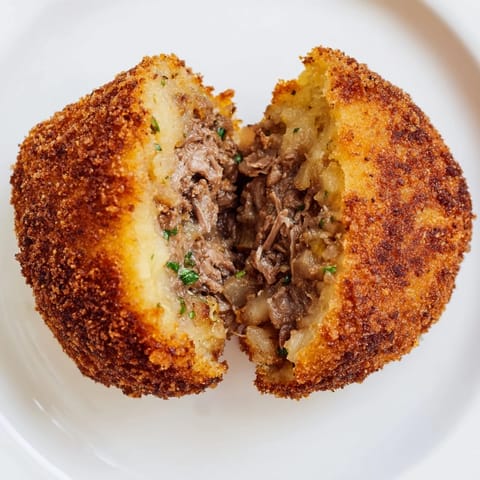 A close-up captures perfectly fried Dutch croquettes, showcasing their breadcrumb crust.