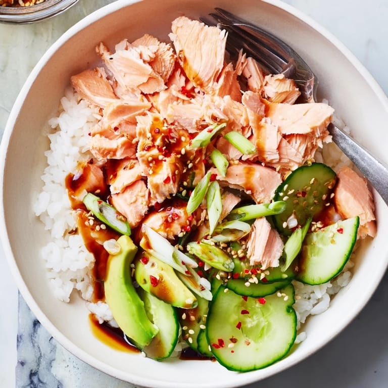 Colorful Leftover Salmon & Rice Bowl topped with pickled ginger and crunchy scallions.