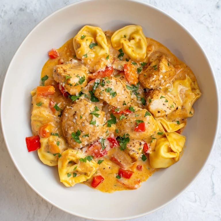 Sizzling Zesty Cajun Garlic Parmesan Chicken Tortellini showcases a rich, cheesy sauce and tender chicken bites.